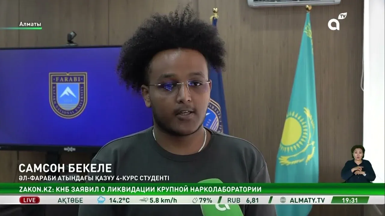 Samson speaking in the Almaty TV News report on AI-Sana.