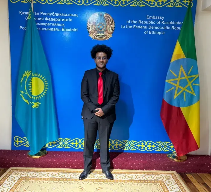 Samson standing between the flags of Kazakhstan and Ethiopia.